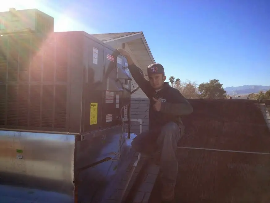 HVAC technician performing Boiler Repair on a rooftop unit in Red Bank
